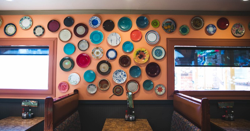 Restaurant booths next to the wall with decorative details
