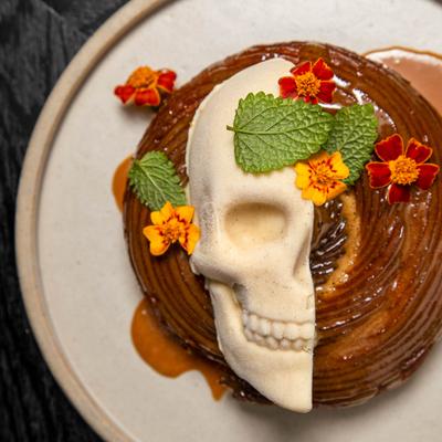 Cinnamon Churro decorated with white chocolate skull.
