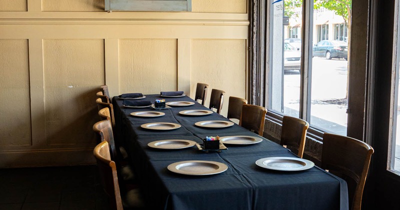 Interior, long dining table ready for guests