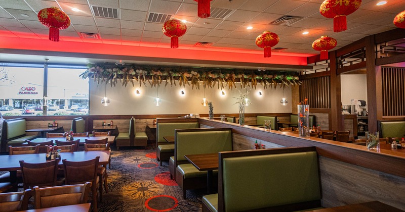 Interior, dining area, seating booths with tables, regular tables for six, carpet flooring