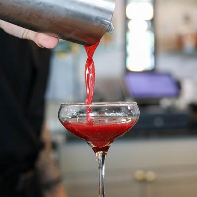 Pouring a blackberry cocktail