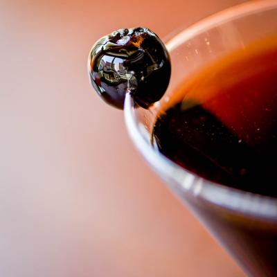 Manhattan Superior garnished with a cherry, close up