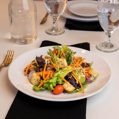 House Salad with mixed greens, cheddar, carrots, tomato, onion, and croutons.