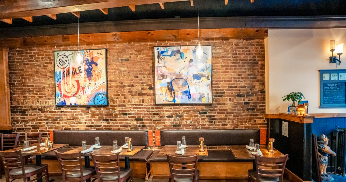 Interior, diner area, booths, chairs, paints on a brick wall