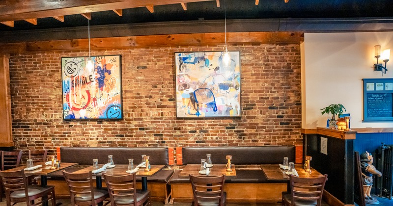 Interior, diner area, booths, chairs, paints on a brick wall