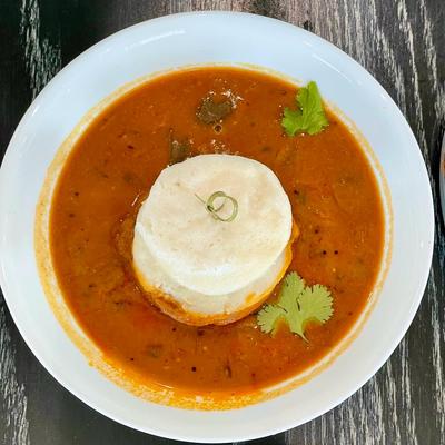 Soft fluffy steamed rice & lentil cake with vegetable lentil stew