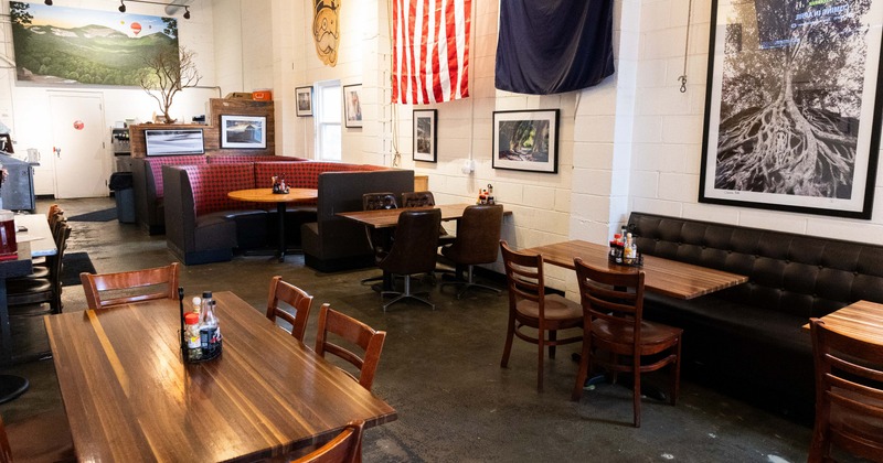 Interior, dining space with leather benches and art on the wall