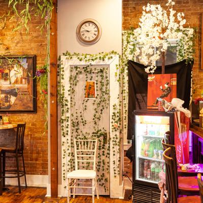 Interior with brick walls, wooden bar and high-top tables.