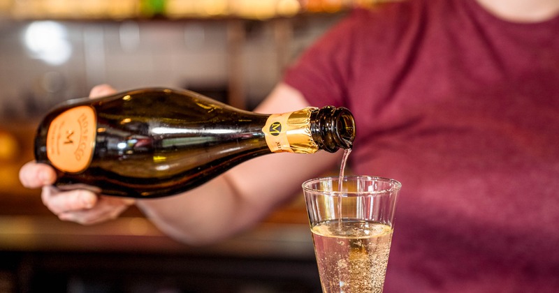 Bartender pouring prosecco in the glass