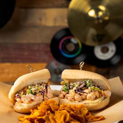 Chicken salad sandwich served chips.