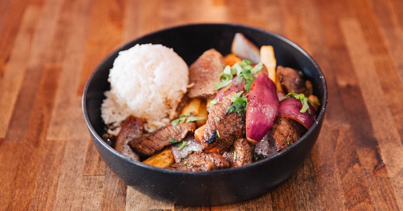 Marinated sirloin steak tips, red onion, tomato, fries, and rice