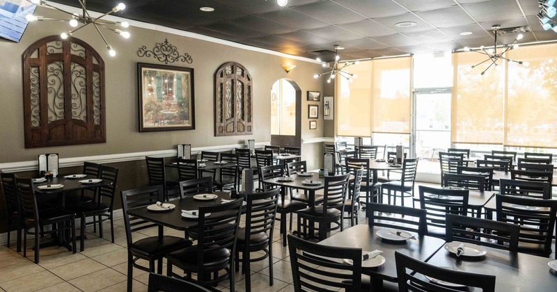 Restaurant interior with dark tables, chairs and decorative wall elements