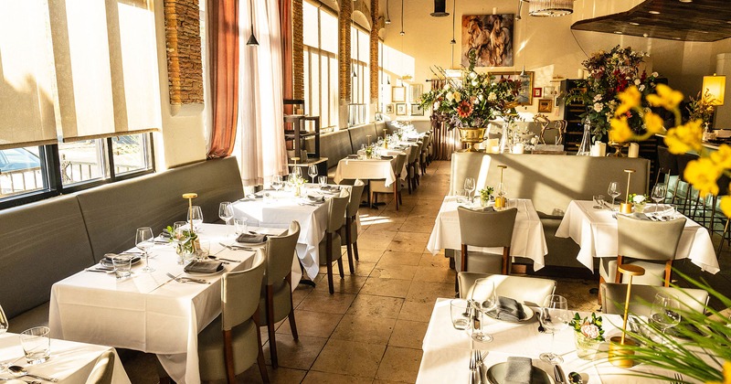Interior, dining area, tables with tableware and glasses