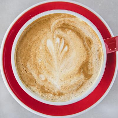 A cup of coffee with milk, top view