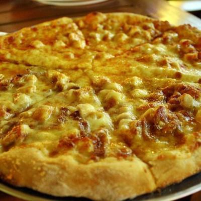 Chicken wing pizza, made with choice wing sauce, Chicken and Mozzarella cheese.