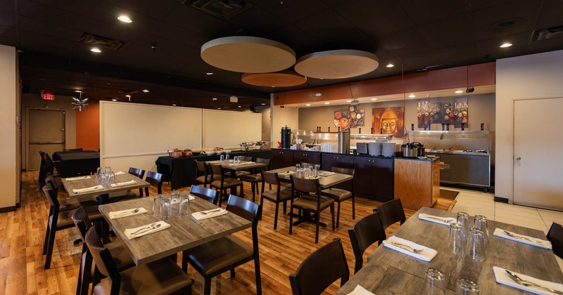 Interior, tables with tableware and chairs
