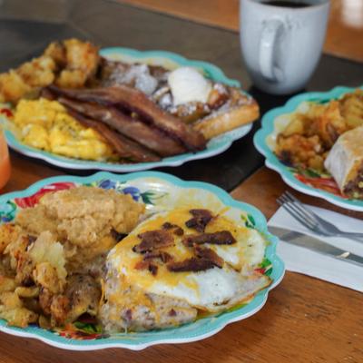 Breakfast dishes served with a coffee.
