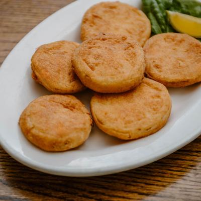 Fried Green Tomatoes served with a lemon wedge.