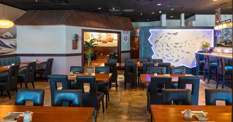 Contemporary restaurant interior with illuminated wall art and seating