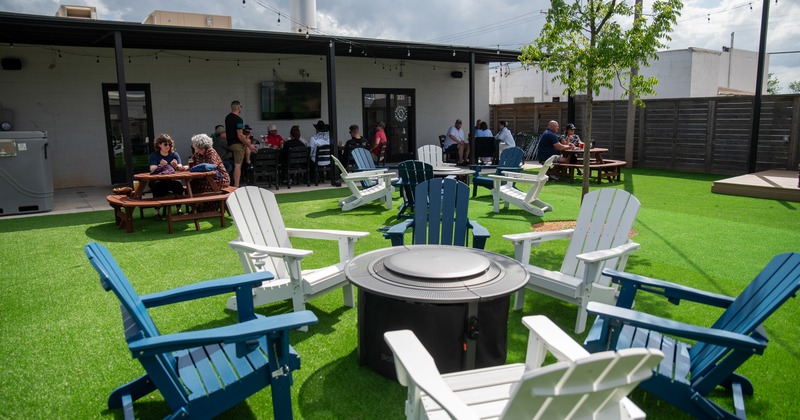 Exterior, lawn, patio, armchairs around the fire place