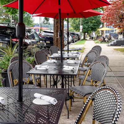 View at outside seatin area with tables, chairs and umbrellas.