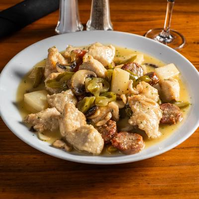 Chunks of chicken and sausage with potatoes, mushrooms, and cherry peppers.