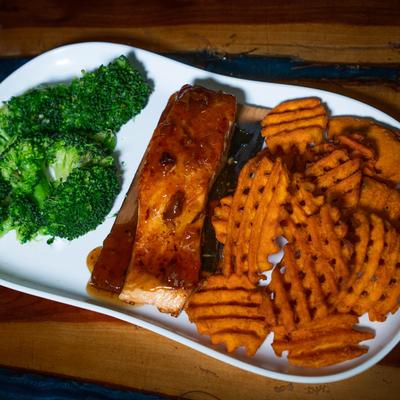 Grilled salmon topped with bourbon bacon glaze, served with waffle fries and broccoli.