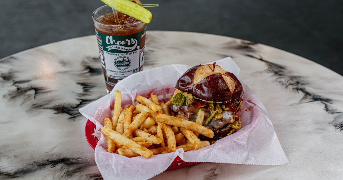 Buffalo Bill burger with fries and pickle spear, served with an iced beverage
