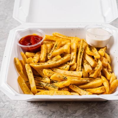 Fries served in a takeout container with dipping sauces.