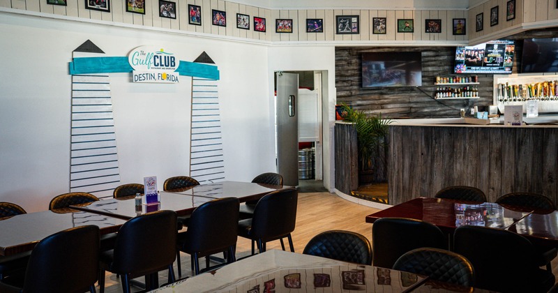 Interior of a sports bar with tables, chairs, a bar counter