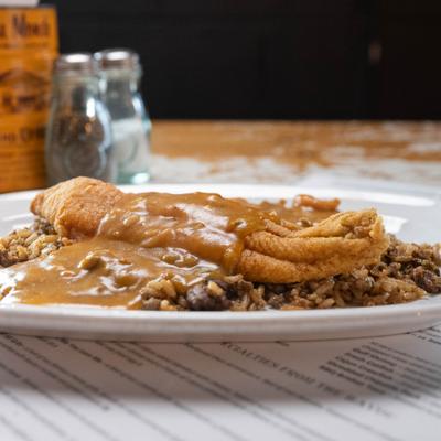 Catfish Atchafalaya over rice topped with brown gravy.
