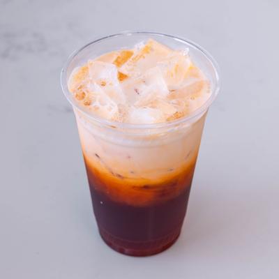 Thai iced tea served in a plastic cup.
