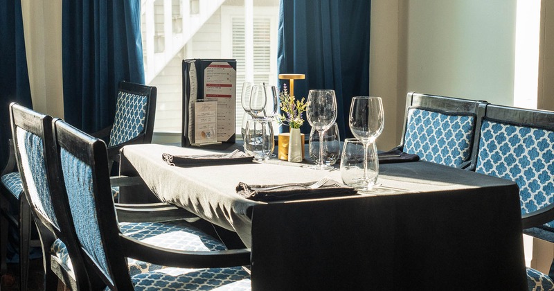 Interior, table ready for guests, wine glasses on table