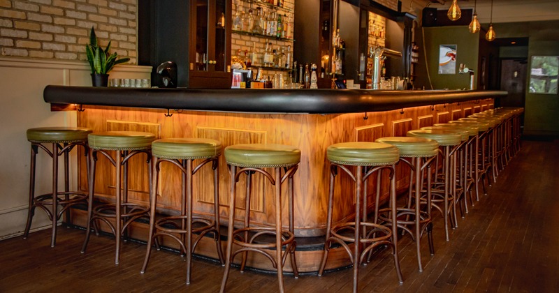 Interior, button tufted booths, dining tables with tableware