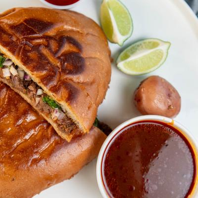 Torta sandwich and birria sauce.