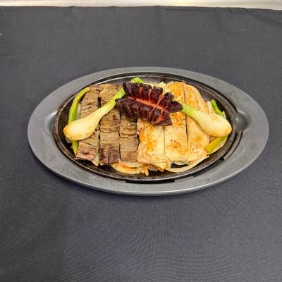 Mixed meat dish, served on a sizzling cast-iron plate..