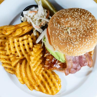 Mother Cluckin' Chicken Sandwich served with coleslaw and waffle fries.