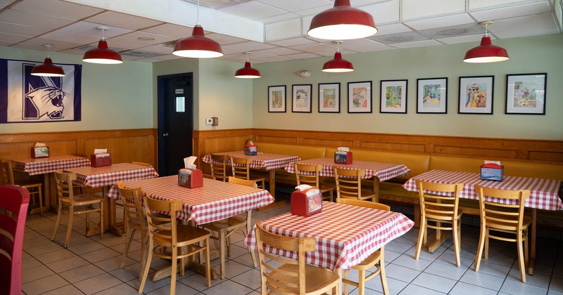 Interior, tables ready for guests, pictures on the walls