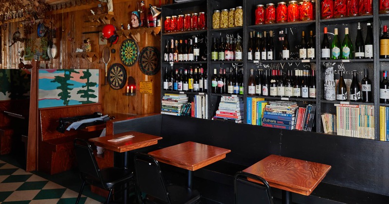 Seating area, various books, bottles and jars on the shelf