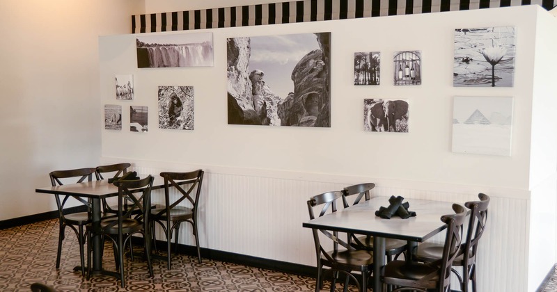 Interior, tables for four by the wall