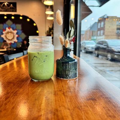 Iced Matcha Latte served on a table by a window.