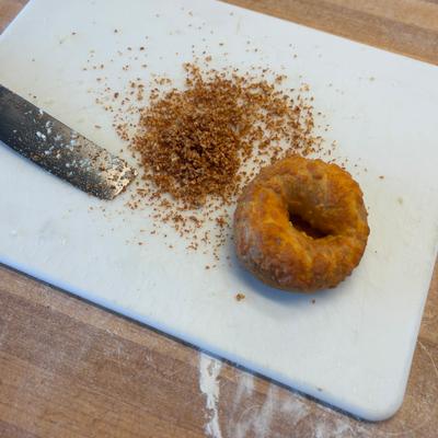 Bagel with seasoning on cutting board Kalis.
