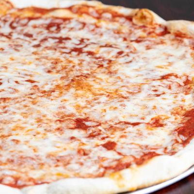 Plain Pizza topped with cheese, close-up.