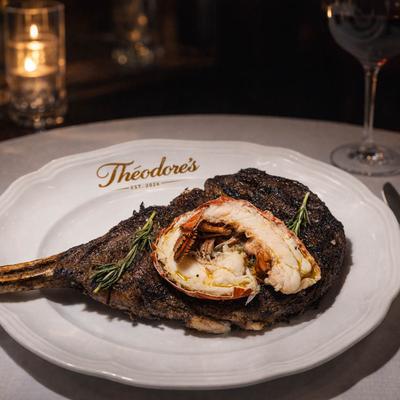 Dry-aged steak topped with a lobster tail and rosemary.