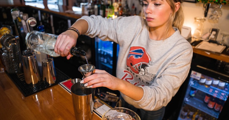 Bartender make a cocktail at the bar