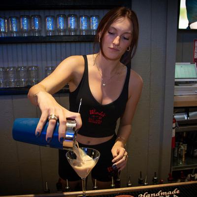 A staff member preparing a cocktail.