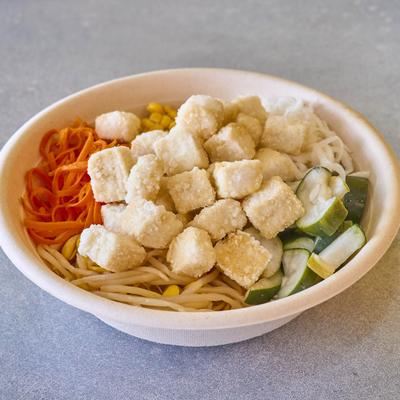 Tofu bowl with various vegetable ingredients.