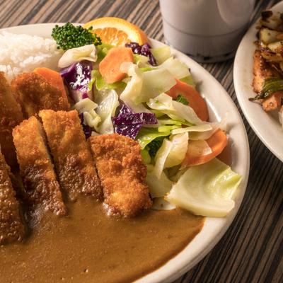 Breaded deep-fried pork loin with special sauce and side of salad.