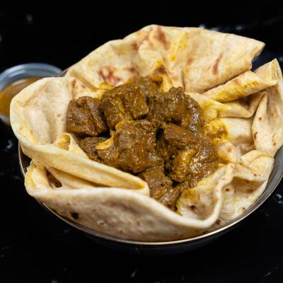 Curry goat served with roti.
