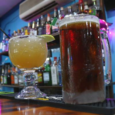 Two drinks on a  bar counter.